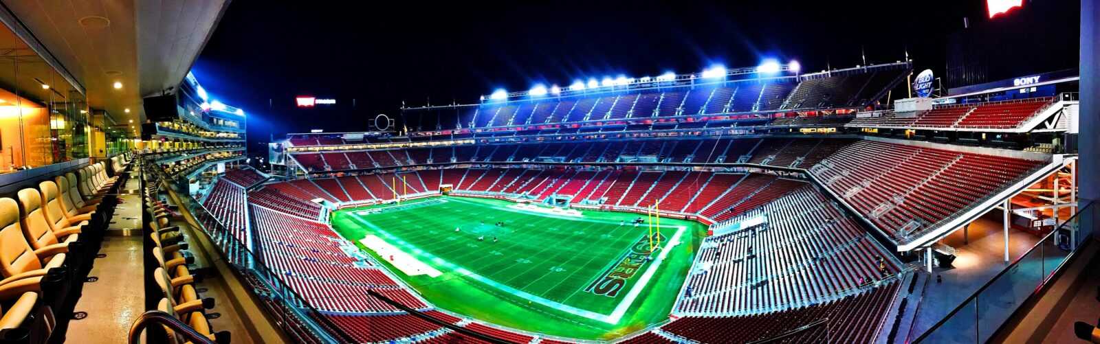 A panoramic night view of Levi's Stadium in Santa Clara, highlighting vibrant lights.